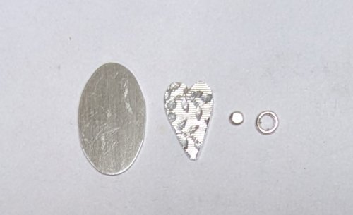 Judy Larson's Hearts and Flowers Charms - , Classic Wire Jewelry, Cutting, Cutting Tool, Cutters, Filing, Finishing, Butane Torch, Soldering, Solder, Design, Place the oval on a bench block.